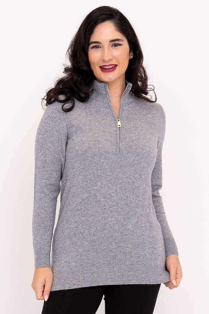 Front view of woman wearing a light grey half zip sweater with long sleeves