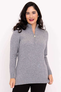 Front view of woman wearing a light grey half zip sweater with long sleeves