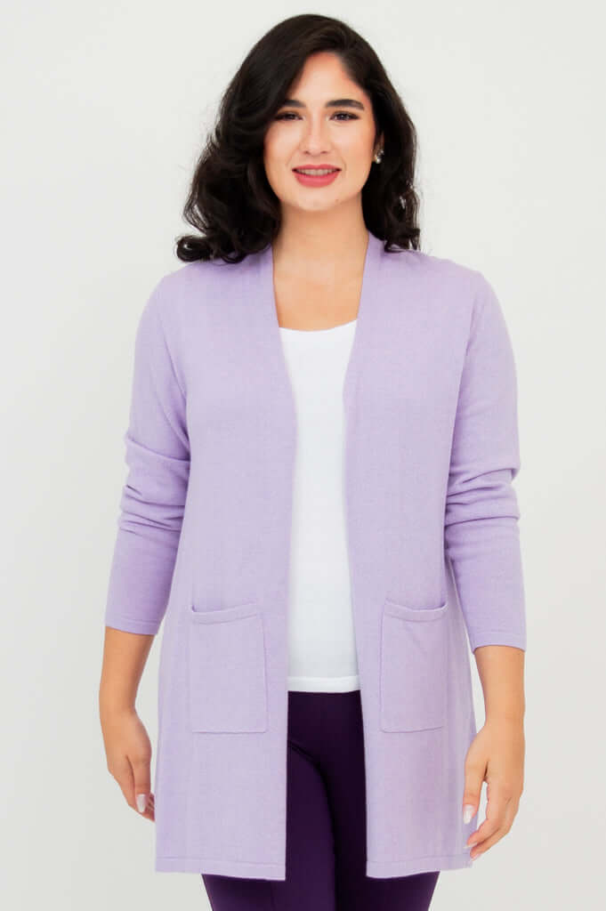 Front view of woman wearing a light purple open cardigan sweater with two pockets