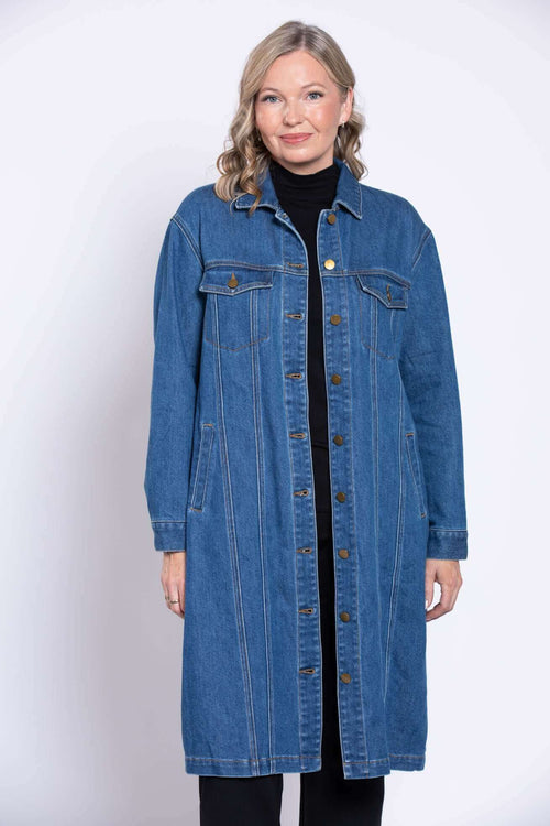 Front view of a woman wearing a longline blue denim jacket with button details