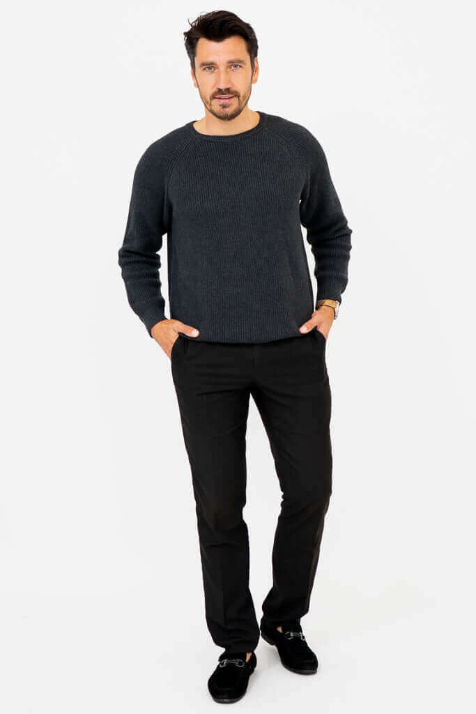 Front view of man in charcoal ribbed crewneck sweater with hands in pockets