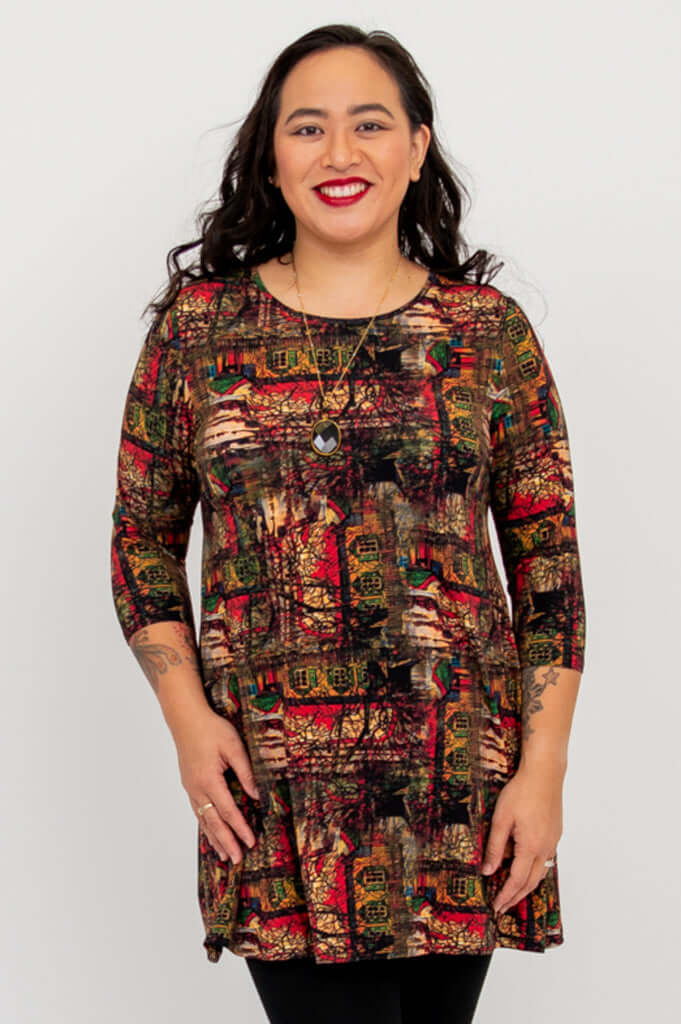 Front view of model wearing Perfect Print bamboo tunic with vibrant artistic pattern