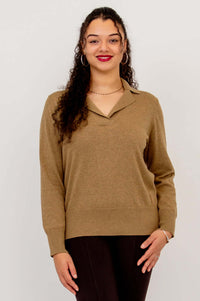 Front view of model in brown V-neck cotton sweater and dark pants