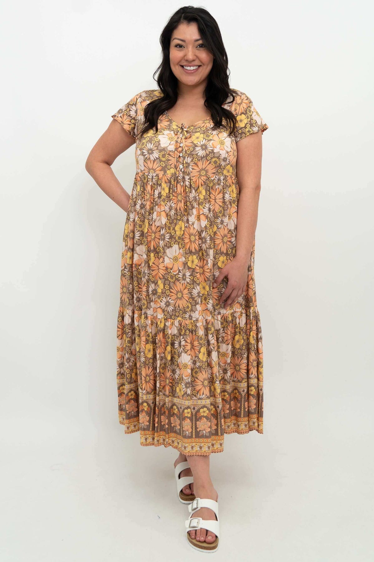Front view of model wearing floral Sharpie Dress with flutter sleeves and tiered skirt