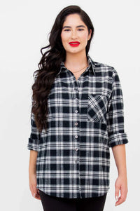 Front view of model wearing Georgia black and white plaid button-up shirt