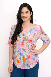 Front view of model wearing floral bamboo linen blouse with elbow-length sleeves