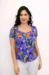 Close up front view of woman wearing a sweetheart neckline purple printed blouse