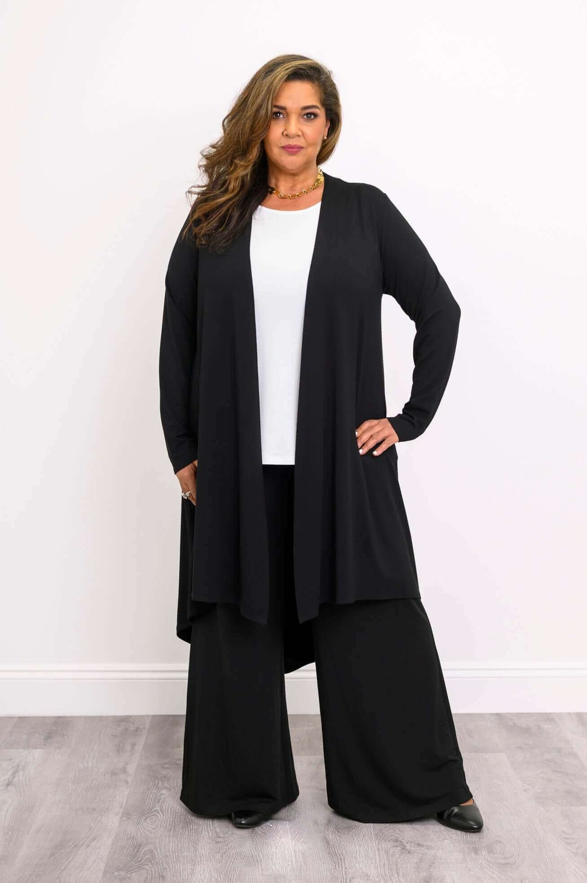 Front view of model wearing a black bamboo duster cardigan with long sleeves