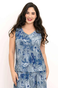 Front view of model wearing a blue floral sleeveless V-neck tank top