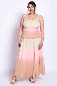 Front view of model wearing a peach and pink dip-dye maxi skirt with matching tank
