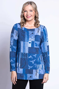 Front view of model wearing blue patchwork tunic with long sleeves