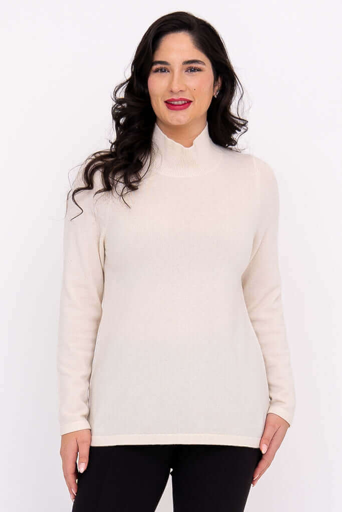 Front view of model wearing cream Simmon Sweater with mock neck