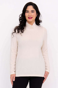 Front view of model wearing cream Simmon Sweater with mock neck
