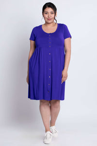 Model standing in a royal purple dress with button-down front and relaxed fit