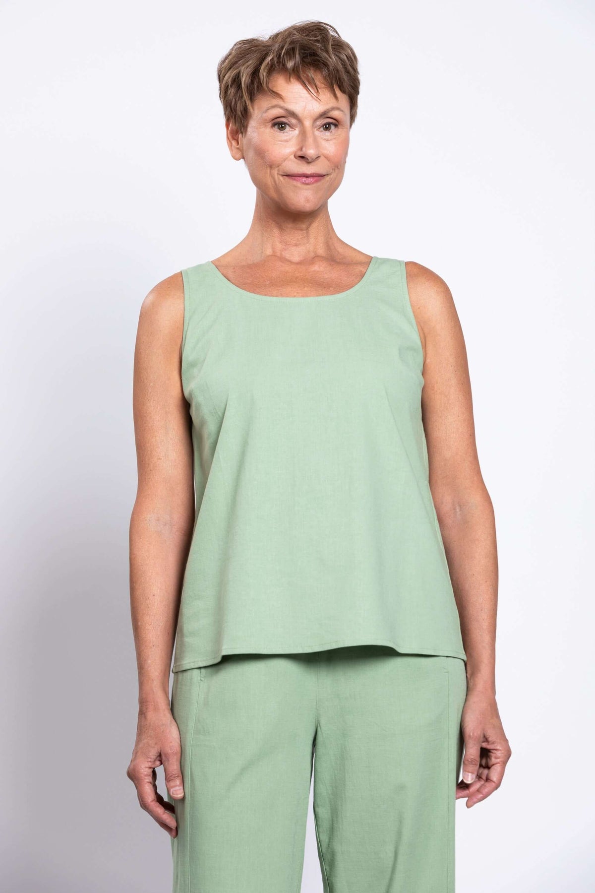 Front view of model wearing sage green sleeveless tank top and matching pants
