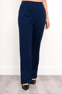 Front view of navy Melodie pants styled with black pointed-toe heels