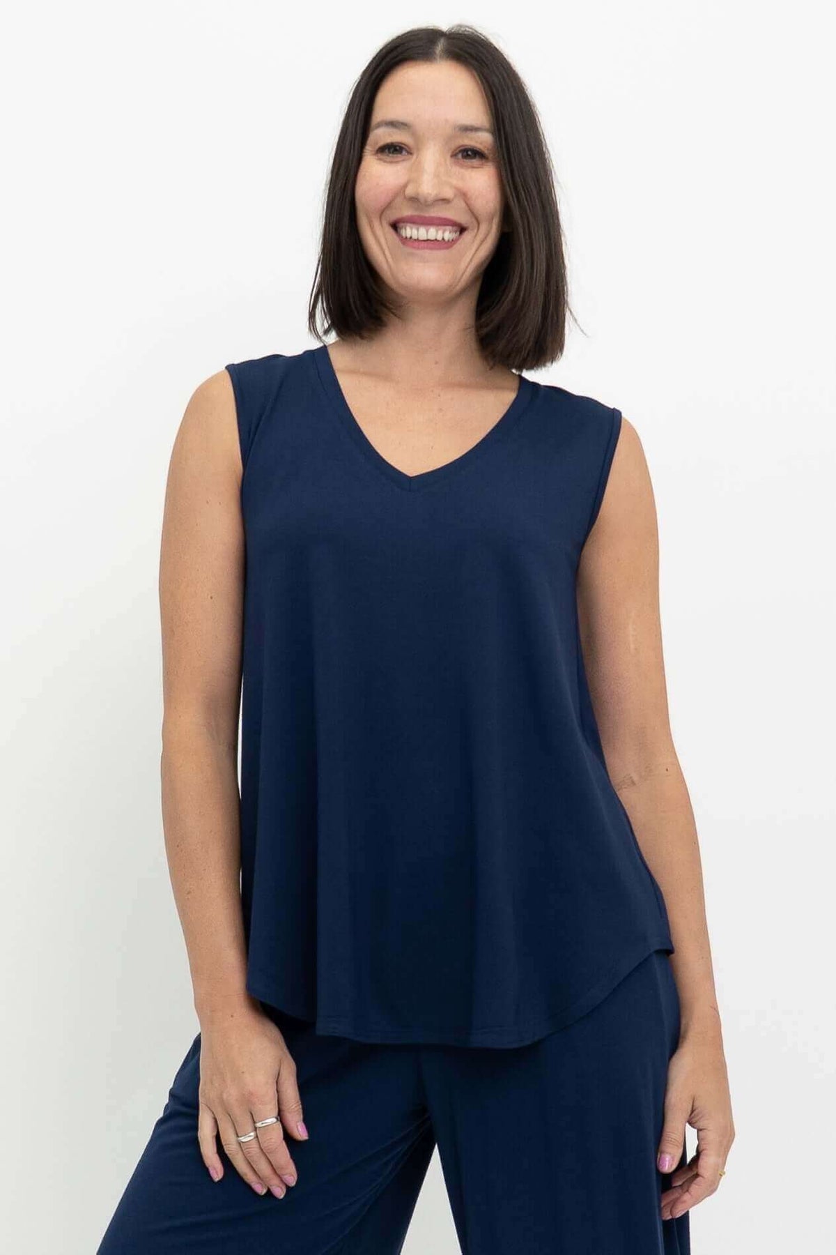 Front view of a woman wearing a navy blue sleeveless V-neck bamboo top