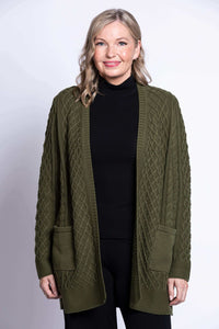 Front view of a woman wearing an olive green cable knit cardigan with patch pockets