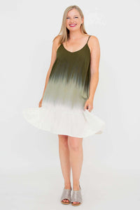 Front view of woman wearing olive ombre tiered dress with flounce hem