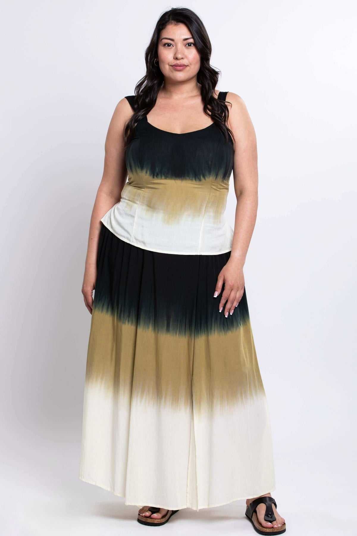 Woman wearing a black, olive, and cream ombre maxi skirt with boho styling, front view