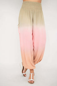 Front view of ombre boho pants with elastic waist and pockets in neutral to peach gradient