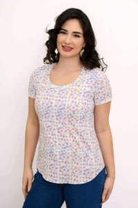 Woman wearing a pastel confetti print scoop neck short sleeve tee, front view