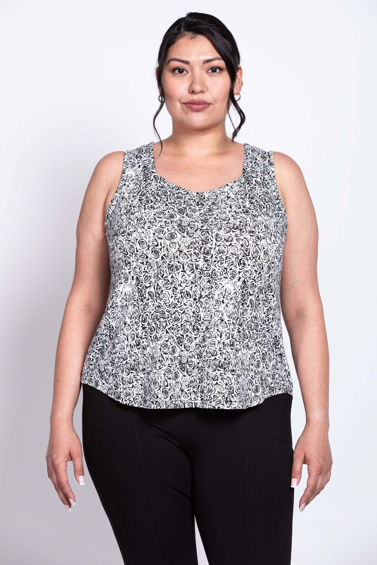 Front view of plus-size model in black and white floral bamboo tank top