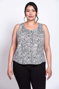 Front view of plus-size model in black and white floral bamboo tank top