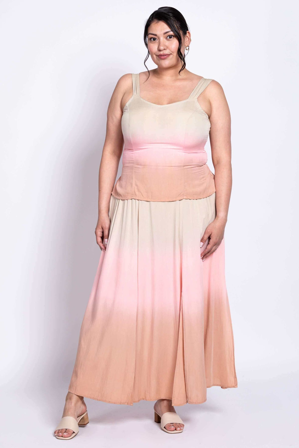 Front view of plus size model in sleeveless ombre maxi dress, beige to peach gradient