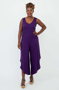 Front view of model wearing sleeveless purple asymmetrical jumpsuit