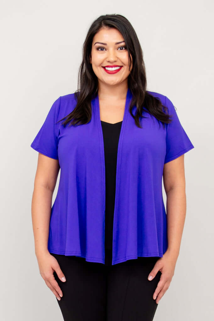 Front view of model wearing a purple short sleeve open jacket over a black top