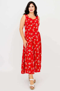 Woman wearing a red sleeveless maxi dress with a floral pattern, front view