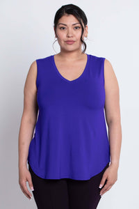 Woman wearing a sleeveless, royal blue V-neck bamboo tank top viewed from the front.