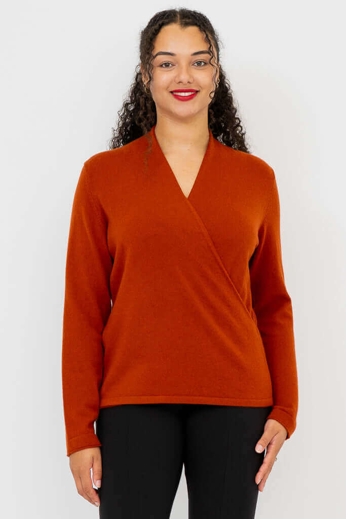 Front view of model wearing rust-colored surplice V-neck sweater