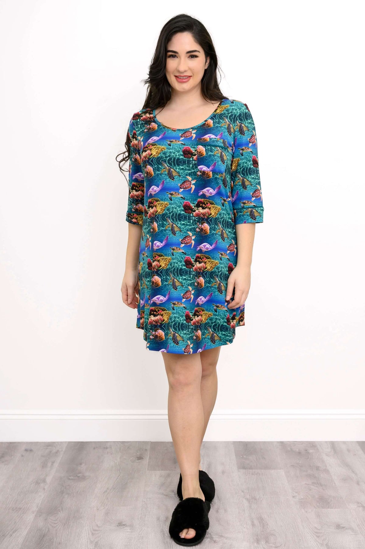 Front view of a woman in a vibrant sea life print bamboo sleepshirt, smiling
