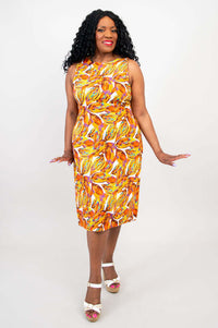 Woman in a printed, sleeveless shift dress with hands out to the sides