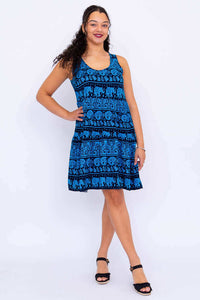 Woman wearing sleeveless blue dress with black elephant print, front view