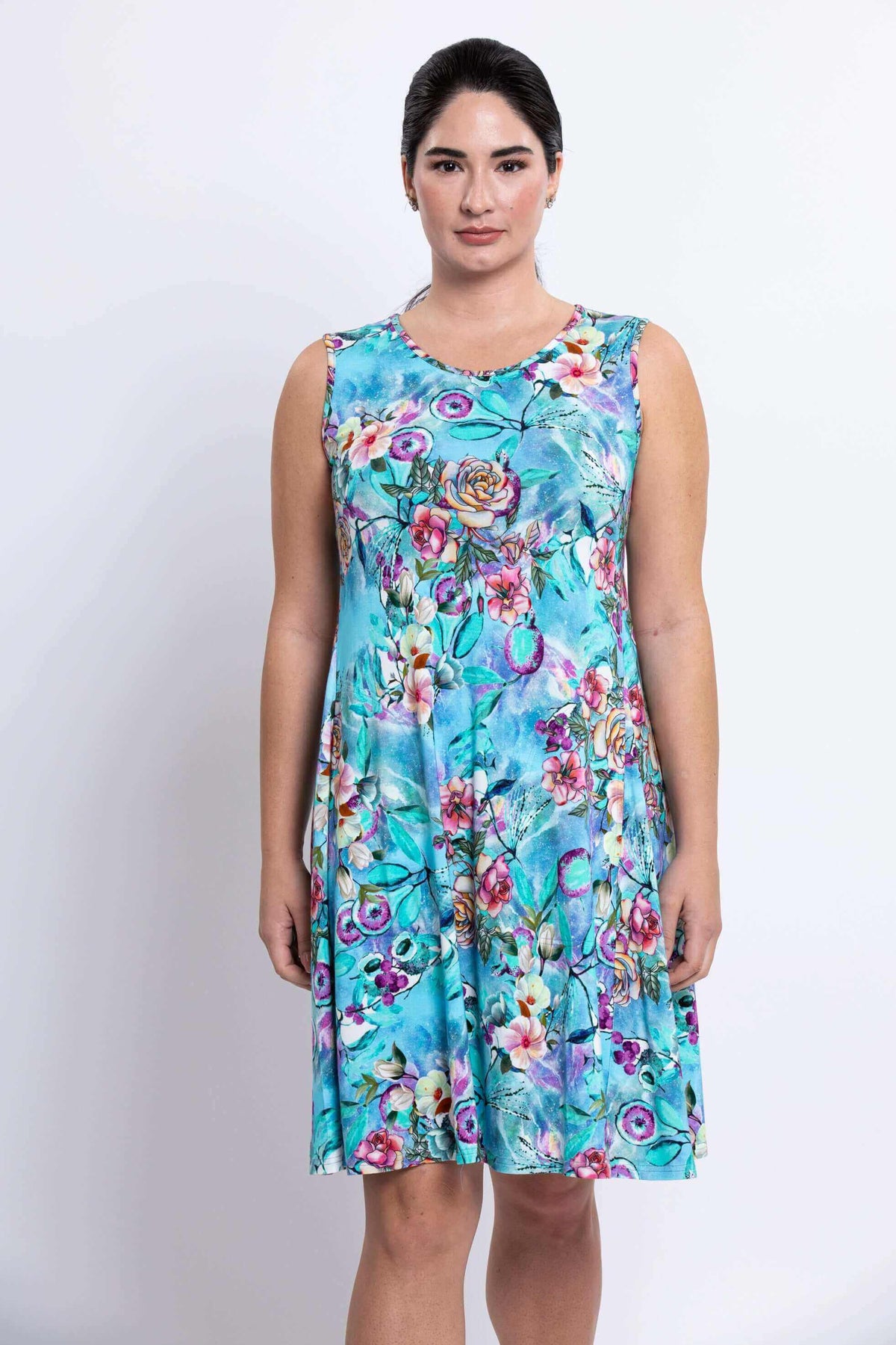 Front view of woman in sleeveless blue floral dress with floral pattern