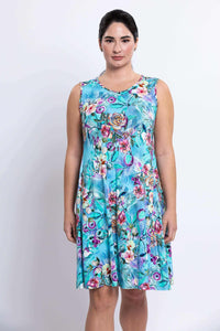 Front view of woman in sleeveless blue floral dress with floral pattern