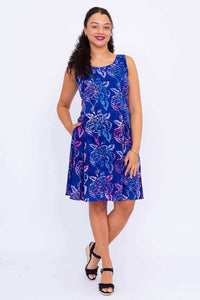 Front view of model wearing a sleeveless blue floral summer dress