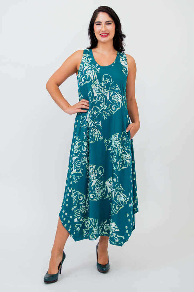 Model wearing a teal sleeveless midi tank dress with floral print, front view