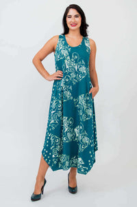 Model wearing a teal sleeveless midi tank dress with floral print, front view
