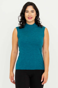 Front view of woman wearing teal sleeveless merino wool mock neck sweater