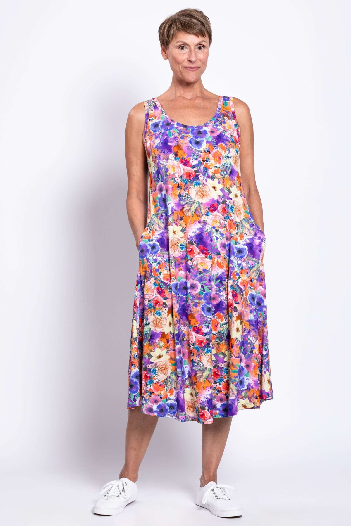 Front view of a woman in a floral bamboo tank dress with pockets