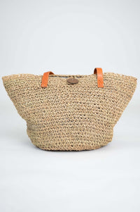 Front view of the Namaste woven rattan tote with leather handles