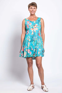 Woman wearing a vibrant blue floral bamboo linen A-line dress, facing forward