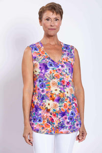 Front view of a woman wearing a colorful floral sleeveless V-neck top