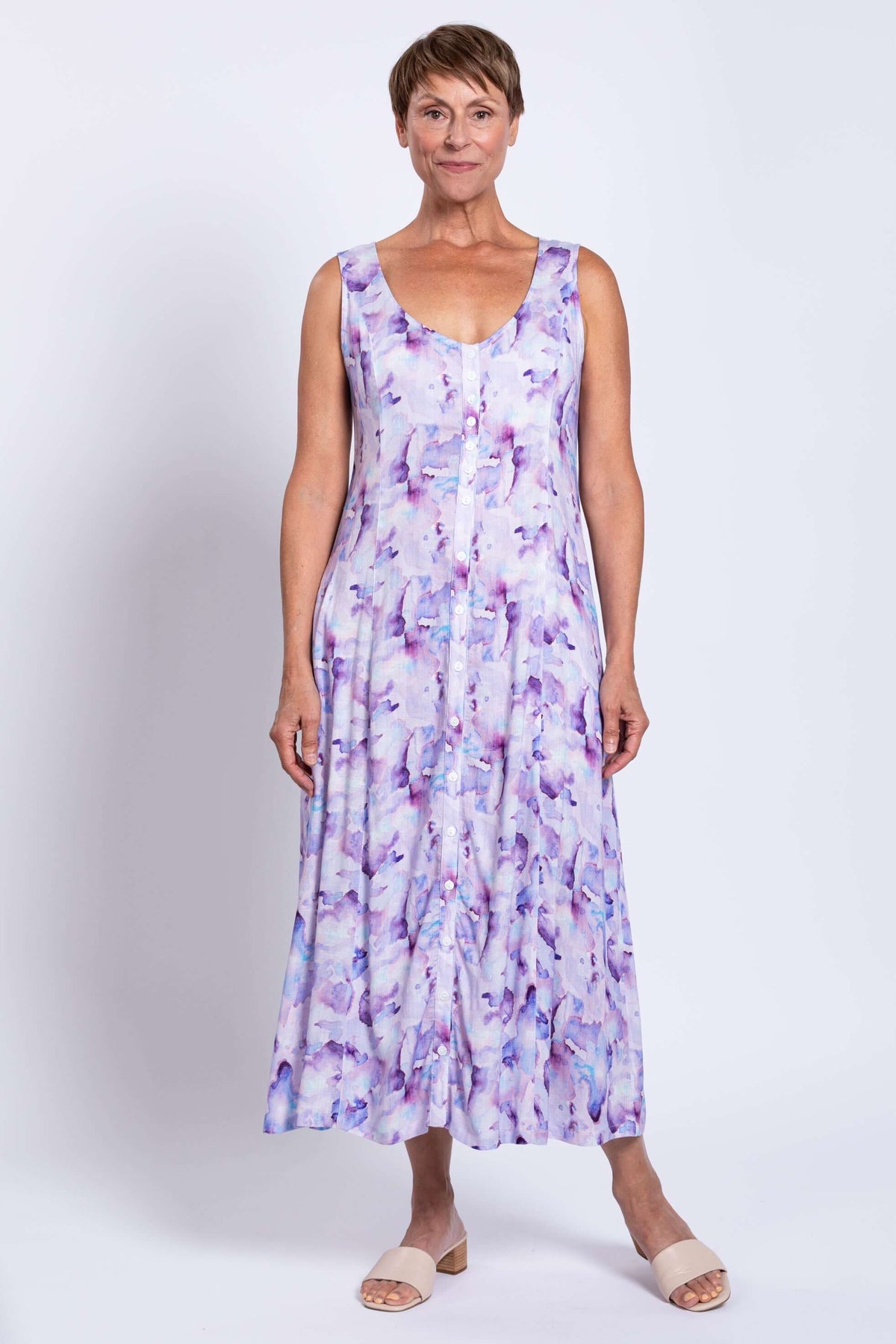 Woman displaying front view of watercolor maxi dress with button detail