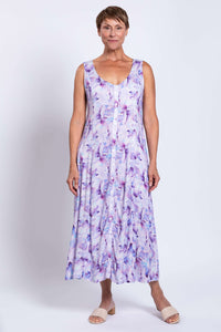 Woman displaying front view of watercolor maxi dress with button detail