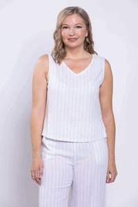Front view of model wearing white striped cropped tank with wide straps